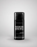 Redken Brews fiber cream bottle on a gray background