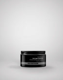 Black jar of Outplay Texture Pomade on a light gray background