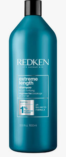 Blue bottle of Redken Extreme Length shampoo on a white background