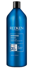 Blue bottle of Redken Extreme Shampoo on a white background