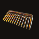 Tortoiseshell comb with 'UC-Pro Japan' branding on a black background