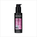 Redken hair product bottle on a white background