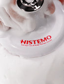 Close-up of a white Histemo scalp therapy device with red branding, covered in white foam, with a hand pressing the metallic button on top.