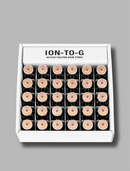 A white box of ION-TO-G Active Factor Hair Tonic containing 20 small dark glass vials with light beige caps, arranged in a grid on a solid gray background.
