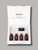 HISTEMO Ion-To G Forte hair treatment set in a white presentation box, containing four small brown bottles and one larger treatment bottle, photographed on a neutral gray background.